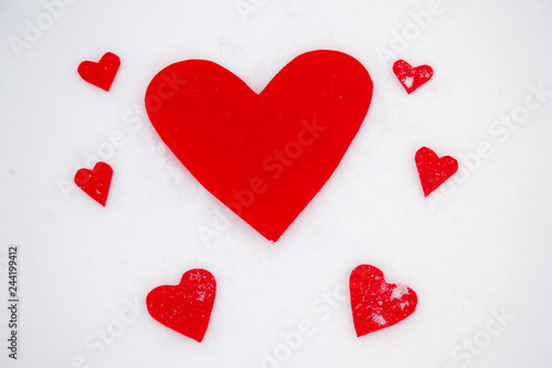 Red hearts on the snow white background