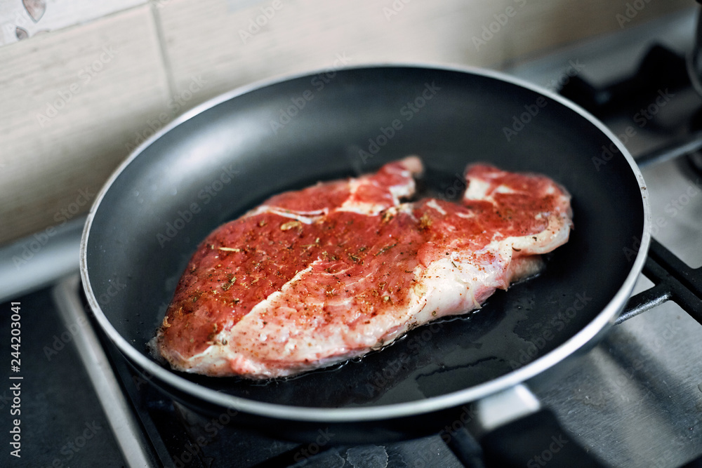 Fototapeta premium juicy grilled steaks in a frying pan