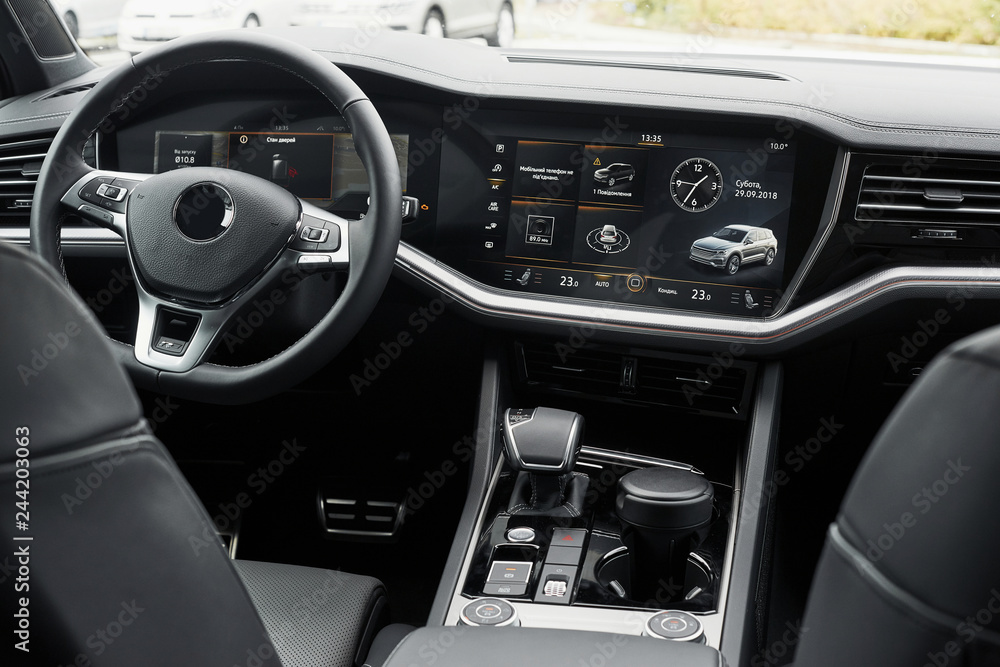 Interior of a prestigious modern black car. Leather comfortable seats and accessories and steering wheel