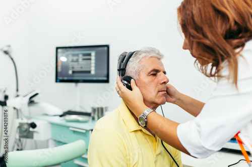 Senior man at medical examination or checkup in otolaryngologist's office