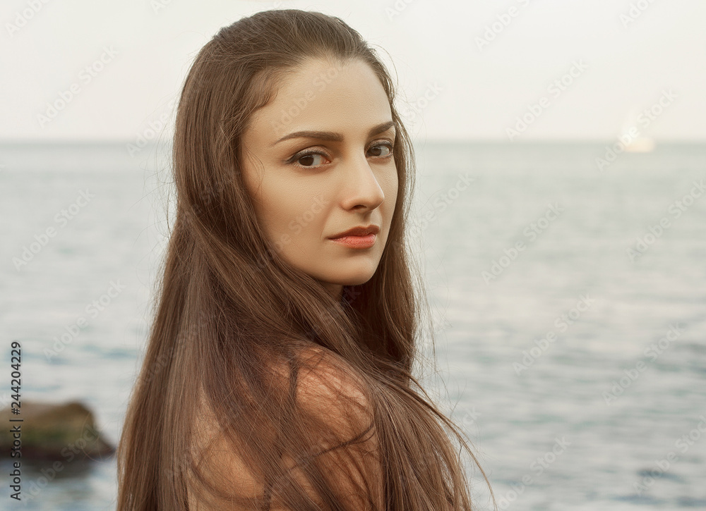 attractive woman resting on the sea background attractive woman resting on the sea background