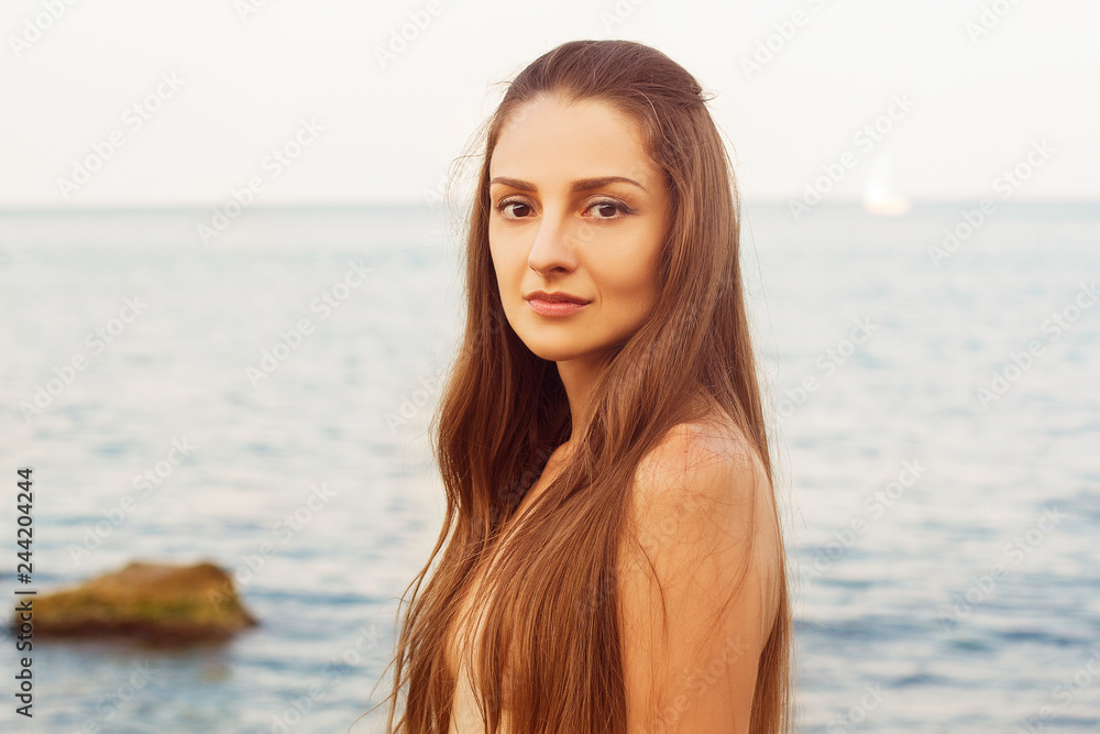 attractive woman resting on the sea background attractive woman resting on the sea background
