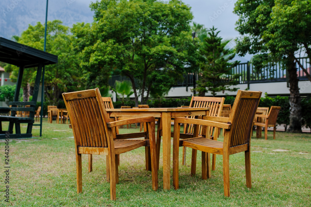 wooden chairs with table outdoors at a hotel in Turkey