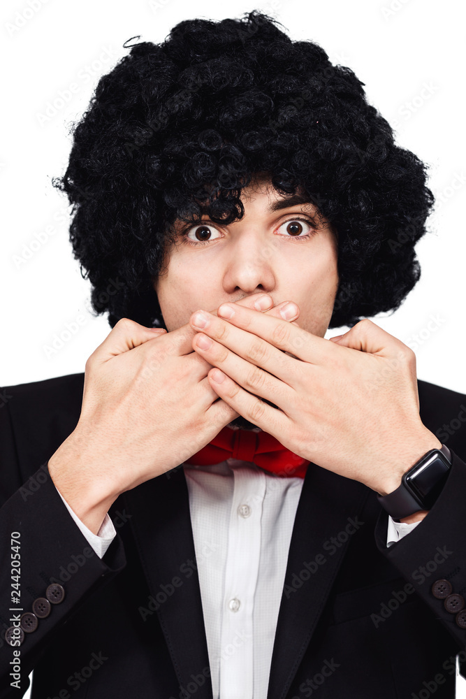 man is afraid to speak. frightened curly bearded guy covers his mouth with his hands man is afraid to speak. frightened curly bearded guy covers his mouth with his hands
