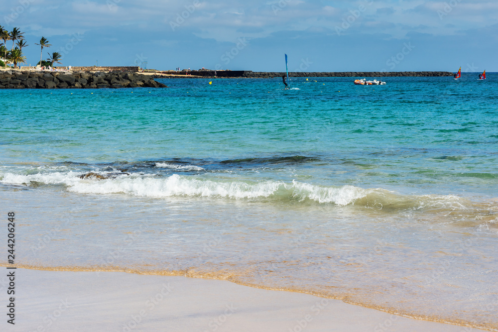 View of Playa de las Cucharas beach in Costa Teguise, Lanzarote, Spain, clear turquoise waters, selective focus