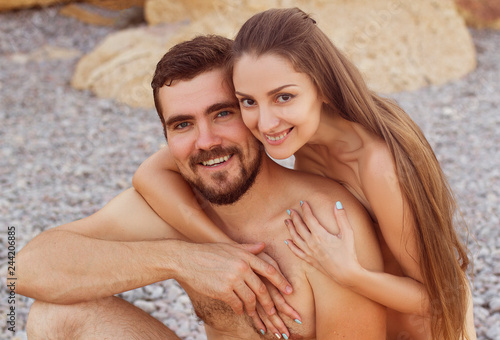 nude couple on the beach hug