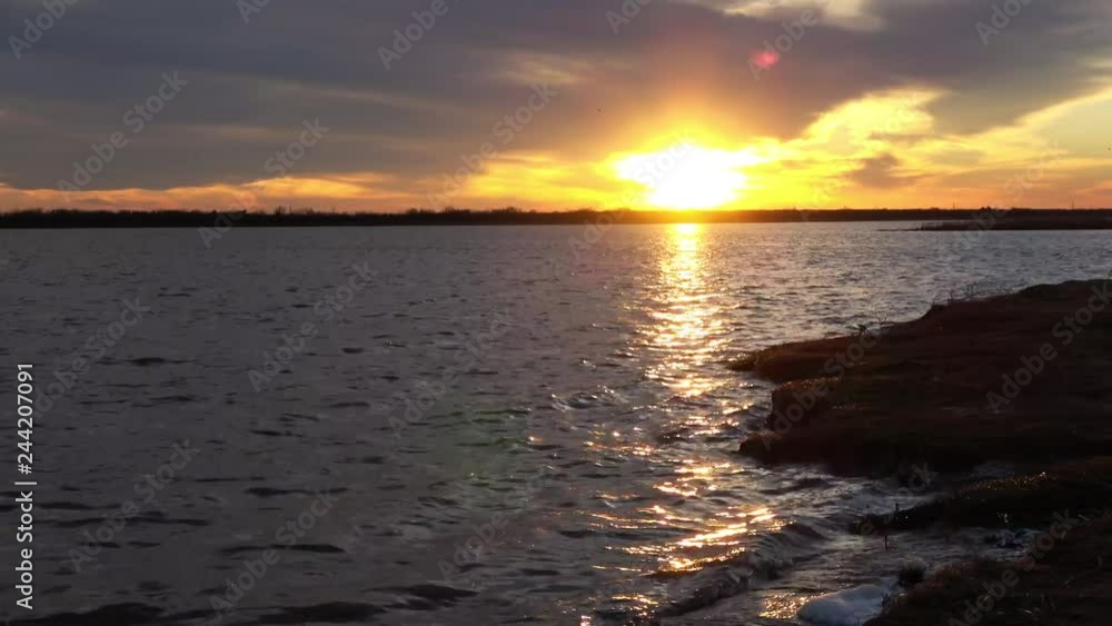 Sunset over lake. View of beautiful sky transition at sunset. Sunset over lake. View of beautiful sky transition at sunset.