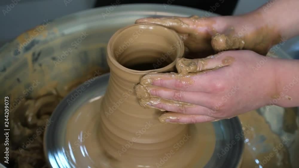 Teaching pottery to children. The teacher gives a master class in modeling Teaching pottery to children. The teacher gives a master class in modeling