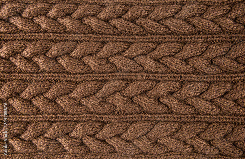 Brown knitted braids fabric textile background. Horizontal lines.
