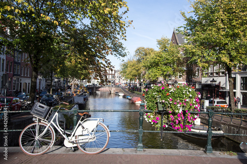 Typical view of canal embankment in historic center of city, Amsterdam, Netherlands.