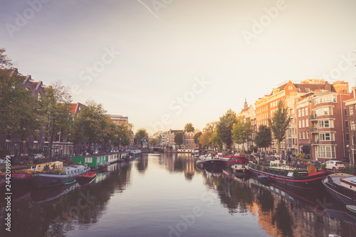 Typical view of canal embankment in historic center of city, Amsterdam, Netherlands.