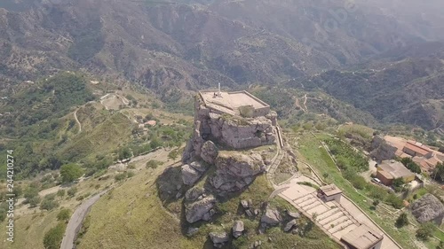 Stunning orbit 4k drone aerial footage around the rock and Catholic cross in Bova, a small Italian village in the hills in Calabria