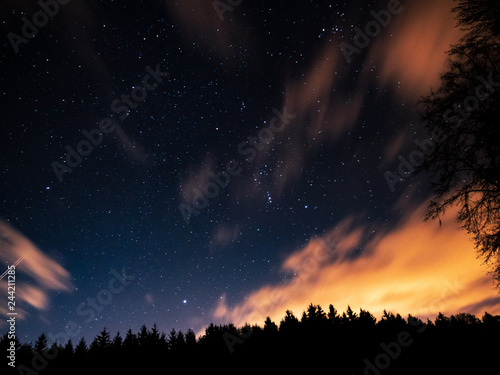 Night sky with stars and clouds during long exposure