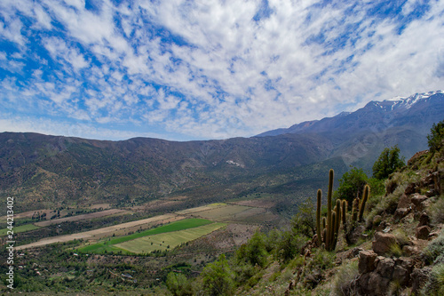 view of the valley between the mountains. view from above. to a residential valley. around the chilean mountains. below the village and ponds