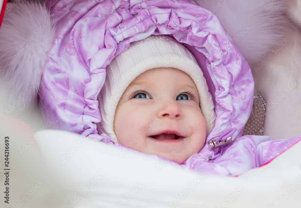 Cute laughing baby girl enjoying a stroller ride Cute laughing baby girl enjoying a stroller ride