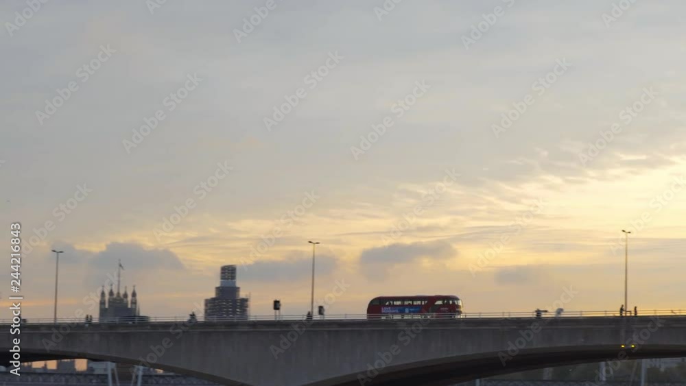 Double decker red bus driving on Westminster Bridge London eye morning view Double decker red bus driving on Westminster Bridge London eye morning view