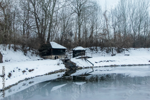Wallpaper Mural Old abandoned water mill near the lake Snowy cloudy day, sunset Torontodigital.ca