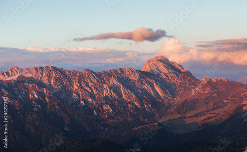 Great dolomite mountains with trees below in daily sunlight