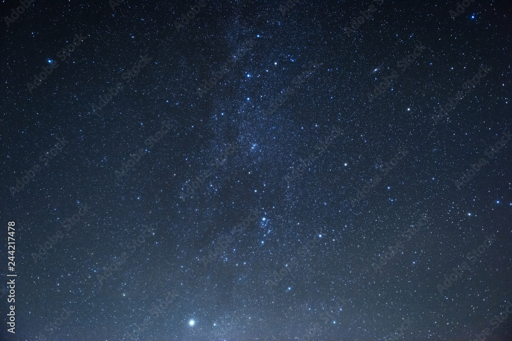 Milky way at center. Photo of beautiful blue night sky filled with stars