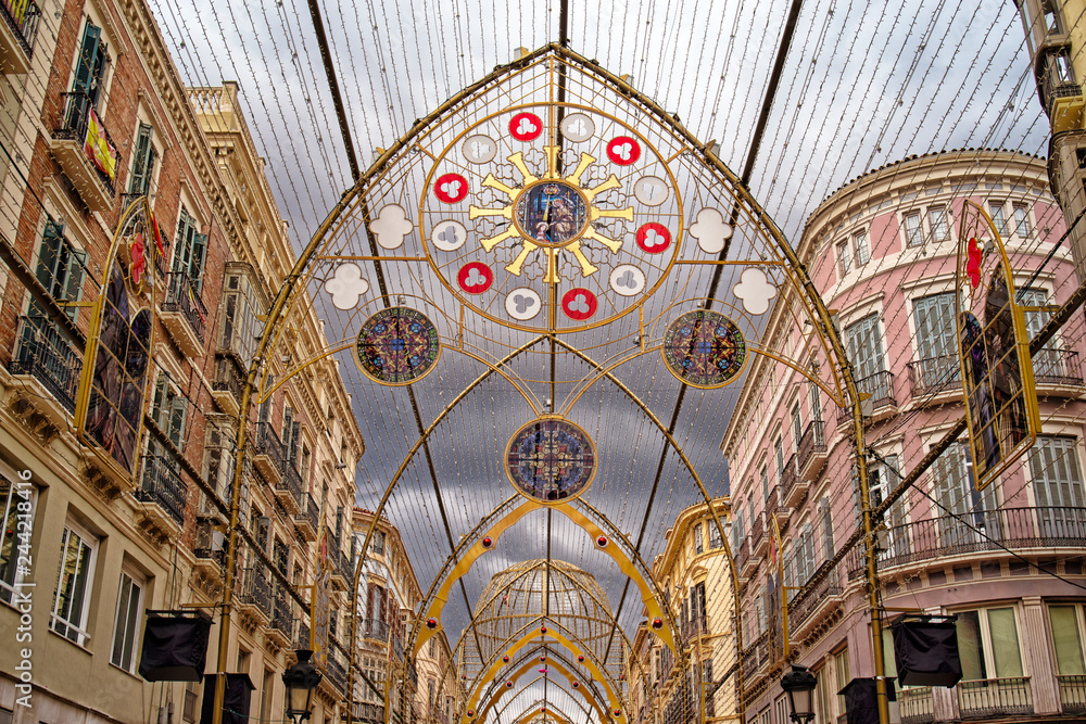 Obraz premium Christmas street decorations in Malaga, Andalucia, Spain. New Year and Christmas lights decorations on the main pedestrian street in the city centre of Malaga.
