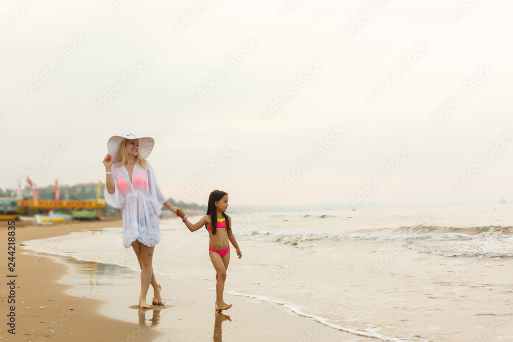 mother and daughter happy in love at sunset