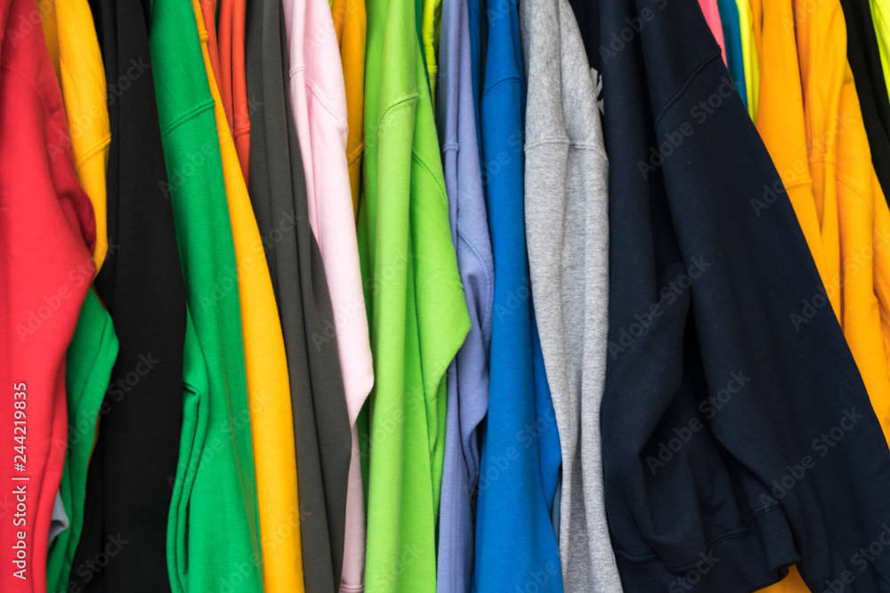 colorful t-shirts for sale at an outdoor market