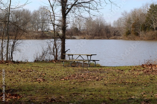 The empty picnic table on the shore of the lake. © Al