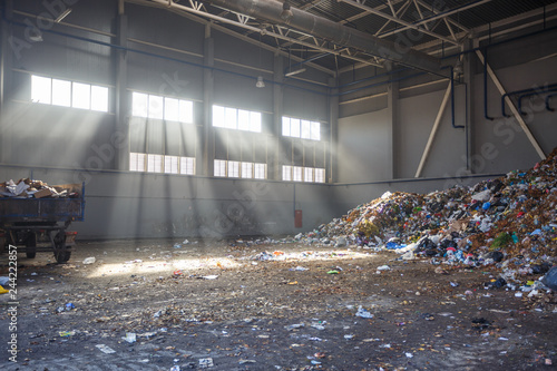 Obraz na plátně trash sorting and recycling workshop with trailer at the waste processing plant with sun rays