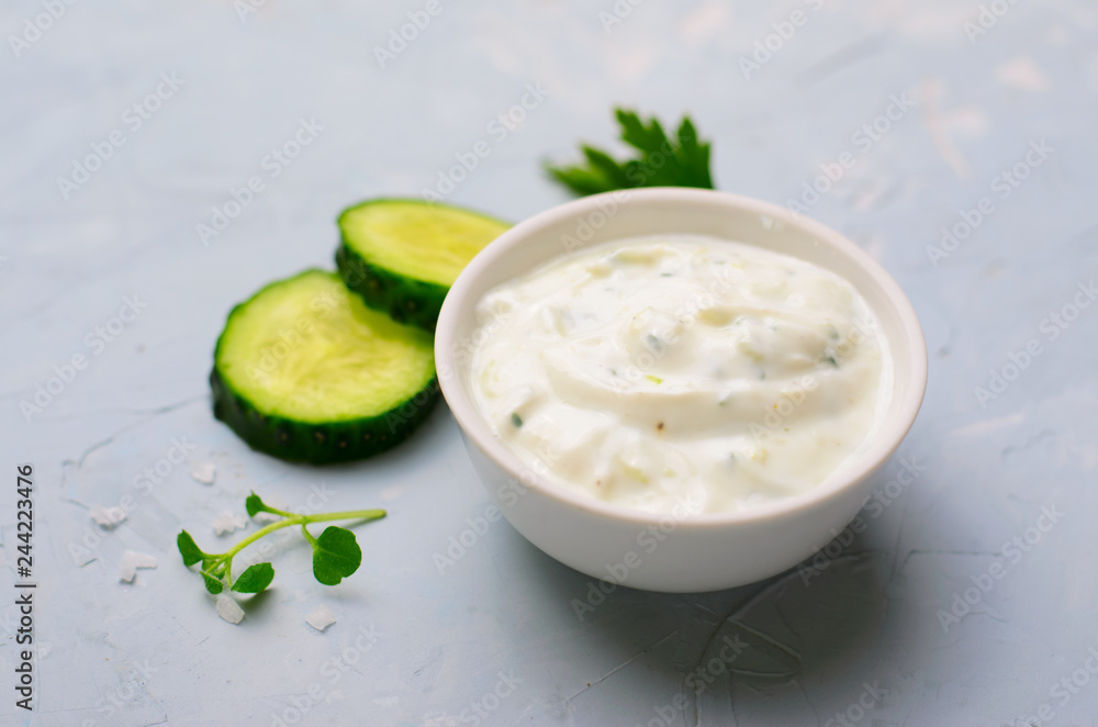 Tzatziki, Yoghurt Sauce with Cucumber on Bright Background Tzatziki, Yoghurt Sauce with Cucumber on Bright Background