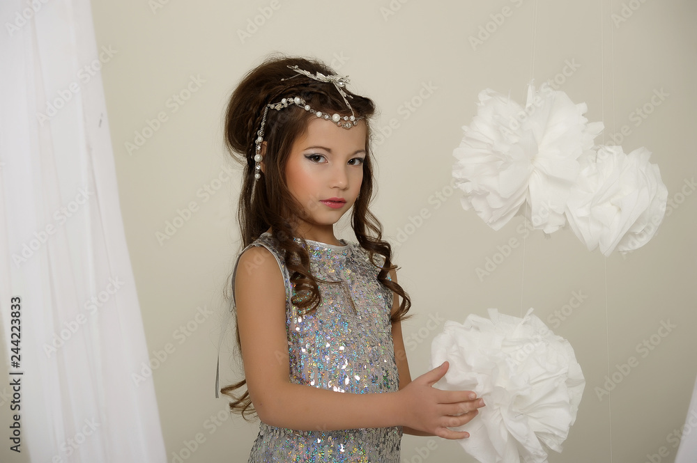 Little girl in a silver dress. Caucasian, attractive. Little girl in a silver dress. Caucasian, attractive.