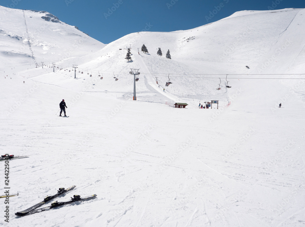 Skier in a slope of a  winter ski resort