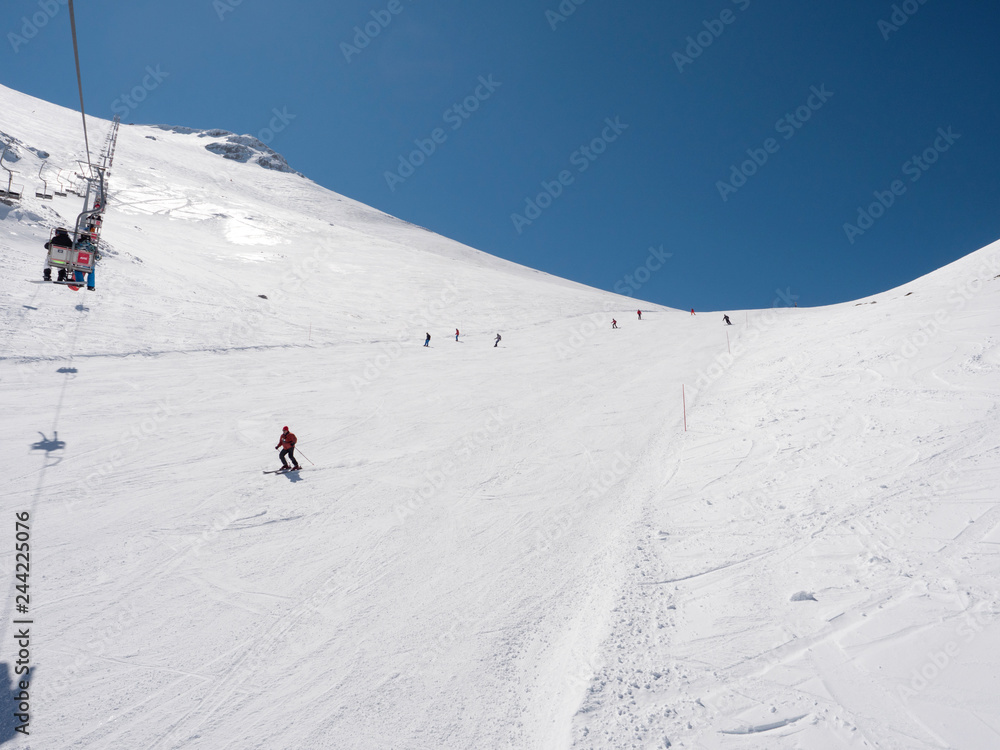 Skier in a slope of a  winter ski resort