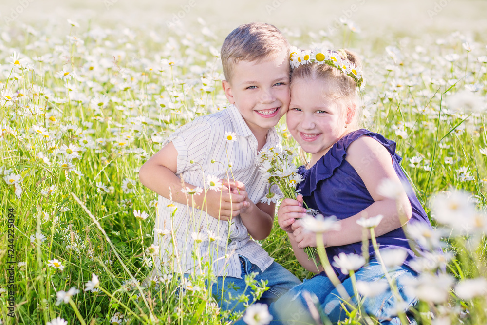Happy little children in a chamomile field Happy little children in a chamomile field