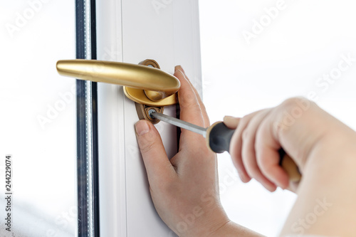 gold pen. Fasten the window handle screw to the PVC window. photo