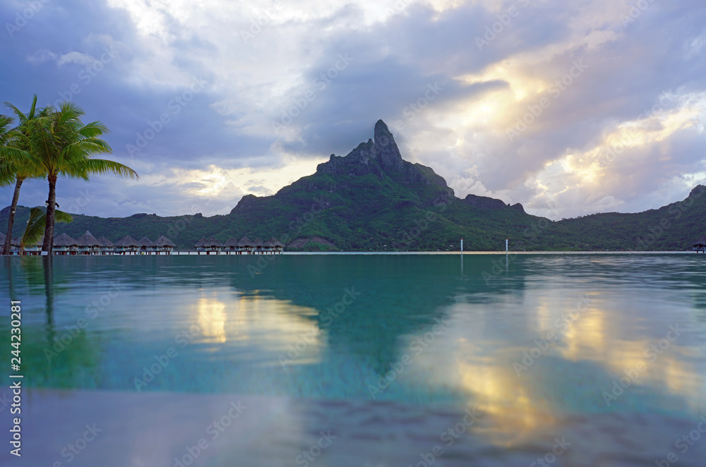 View of the Mont Otemanu mountain reflecting in water at sunset in Bora Bora, French Polynesia, South Pacific