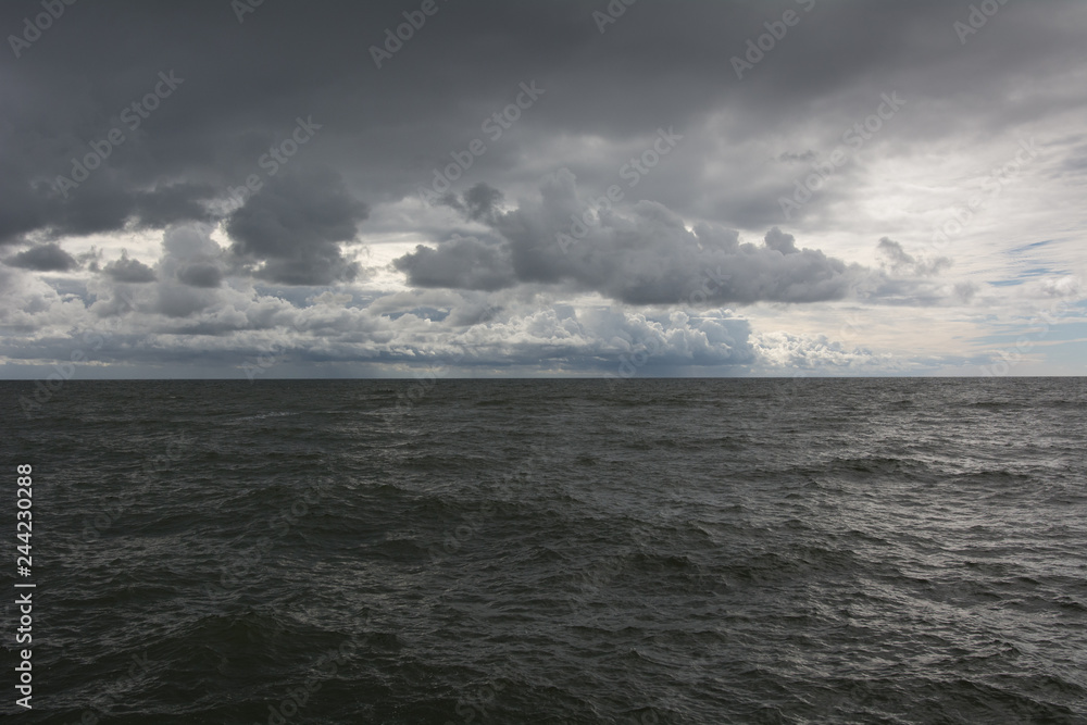 Panorama of dark sky and sea waves 