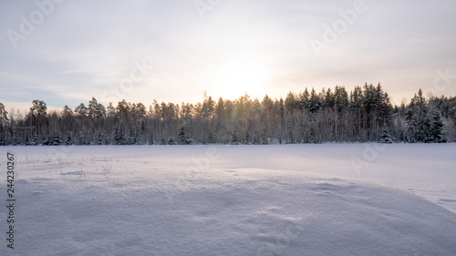 Sunset over a field covered with snow. January 2019, Turku Finland.