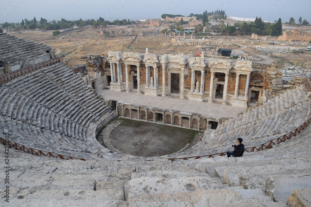 Theater antique. The woman in white in the ancient theatre. The ancient stairs. Antique staircase in the ancient theater. Pamukkale. Denizli. Turkey	