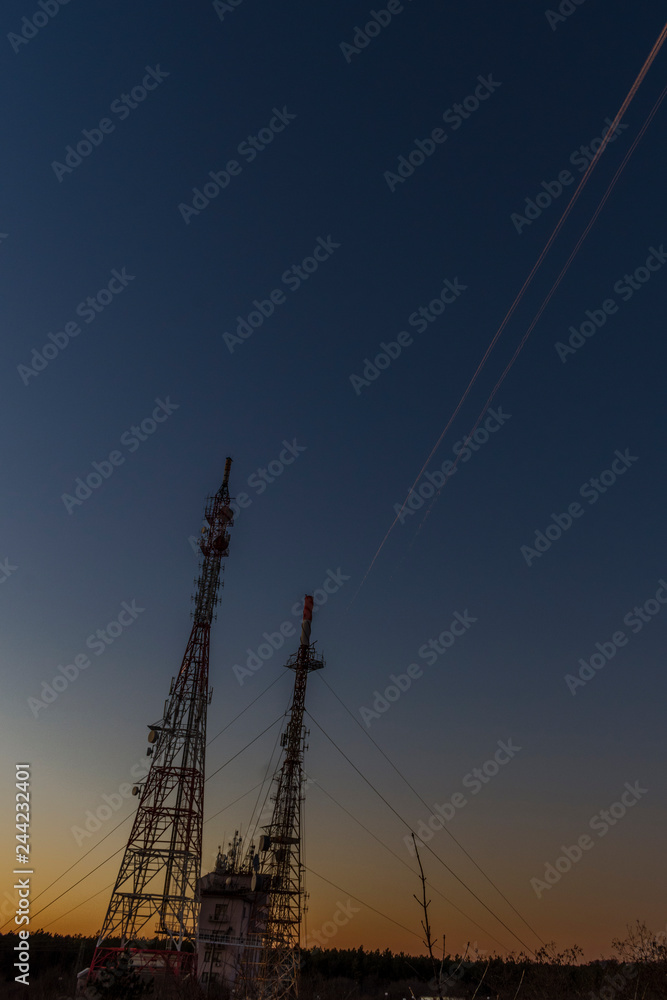 Fototapeta premium Traces of airplanes in the sky on a summer night.