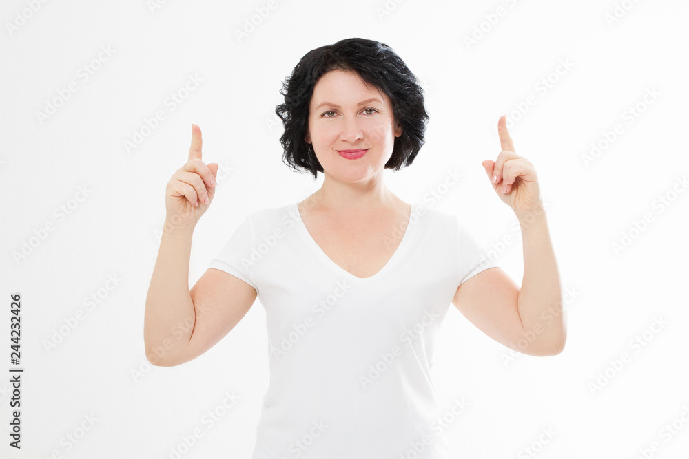 Happy middle age woman in summer blank template t shirt isolated on white background showing copy space by fingers. Mock up Happy middle age woman in summer blank template t shirt isolated on white background showing copy space by fingers. Mock up