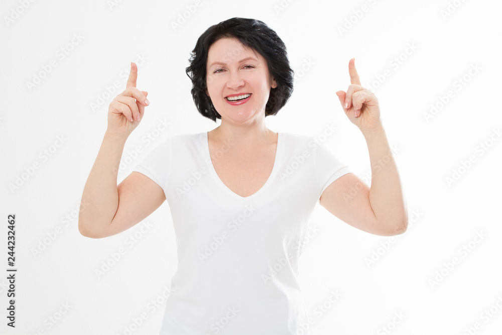 Happy middle age woman in summer blank template t shirt isolated on white background showing copy space by fingers. Mock up Happy middle age woman in summer blank template t shirt isolated on white background showing copy space by fingers. Mock up
