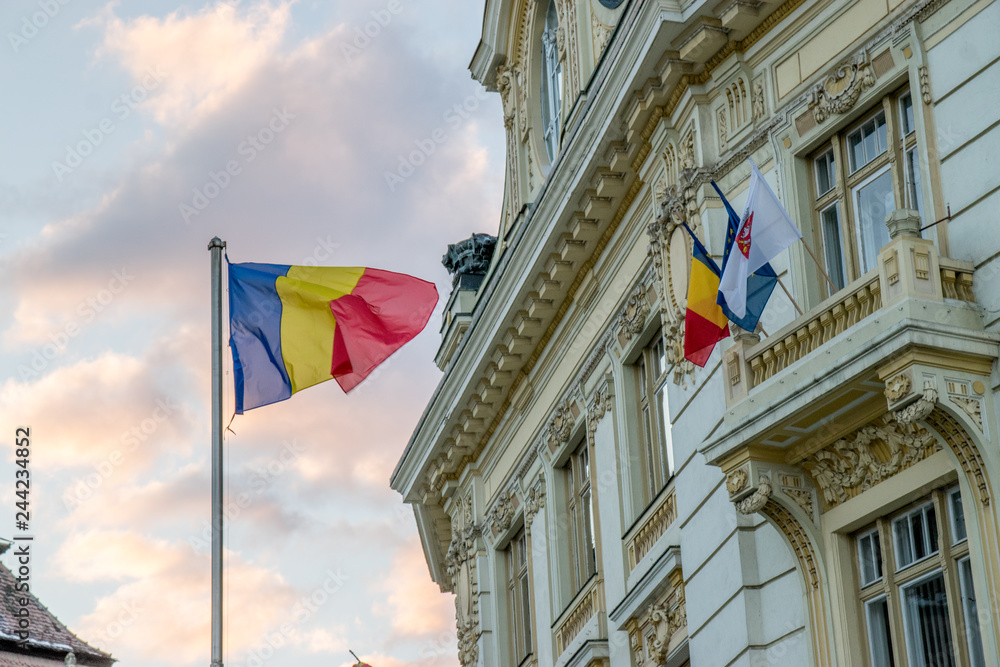 The City Hall of Sibiu and the flags of the country, the European Union and the city itself in Sibiu, Romania