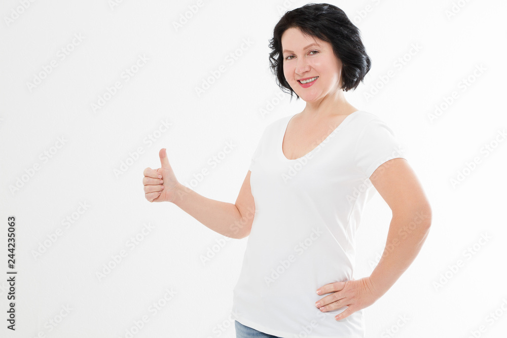 Middle age woman with perfect white teeth smile isolated on white background. Dental medicine and wrinkle skin care concept. Copy space. Big thumb up Middle age woman with perfect white teeth smile isolated on white background. Dental medicine and wrinkle skin care concept. Copy space. Big thumb up