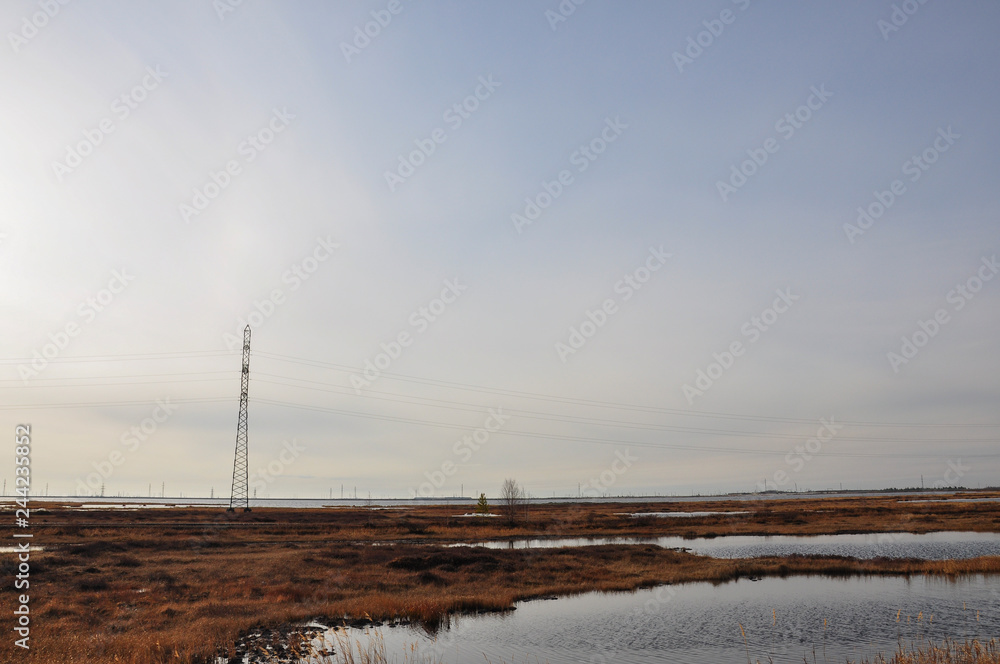 White sun in the cold autumn sky over rivers and lakes. Travelling. Tundra White sun in the cold autumn sky over rivers and lakes. Travelling. Tundra