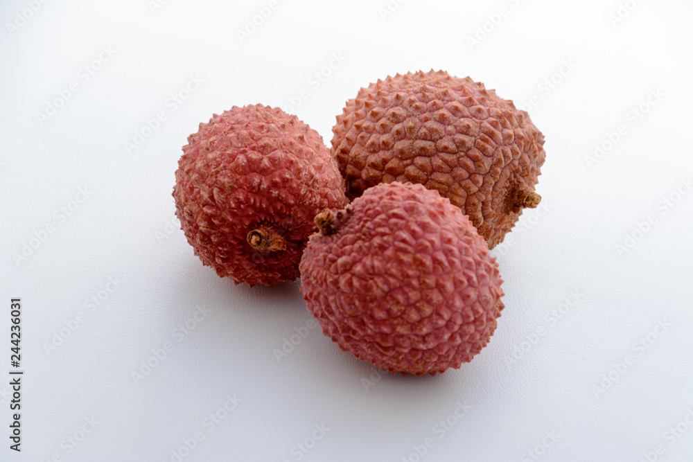 Lychee (LEE-chee; Litchi chinensis) is the sole member of the genus Litchi in the soapberry family, Sapindaceae. Three lychee is on a white background. Tropical fruit. Lychee (LEE-chee; Litchi chinensis) is the sole member of the genus Litchi in the soapberry family, Sapindaceae. Three lychee is on a white background. Tropical fruit.