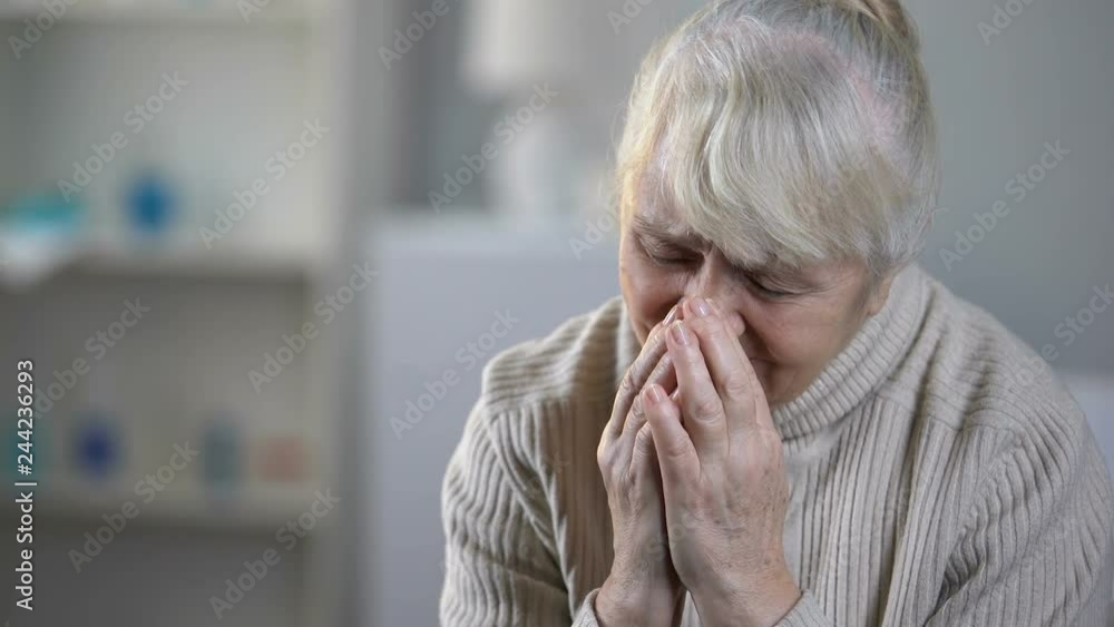 Upset elderly female patient crying in hospice, incurable disease, depression Upset elderly female patient crying in hospice, incurable disease, depression