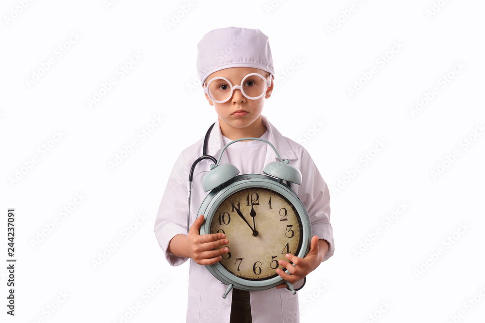 A little, smiling boy doctor in medical uniform, isolated on white, with stethoscope on the neck, reminds you about health care and healthy lifestyle. Waist up portrait, looking at camera. A little, smiling boy doctor in medical uniform, isolated on white, with stethoscope on the neck, reminds you about health care and healthy lifestyle. Waist up portrait, looking at camera.