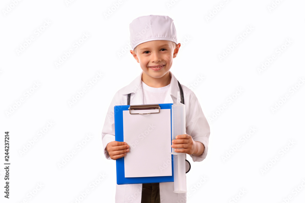 A little, smiling boy doctor in medical uniform, isolated on white, with stethoscope on the neck, reminds you about health care and healthy lifestyle. Waist up portrait, looking at camera. A little, smiling boy doctor in medical uniform, isolated on white, with stethoscope on the neck, reminds you about health care and healthy lifestyle. Waist up portrait, looking at camera.