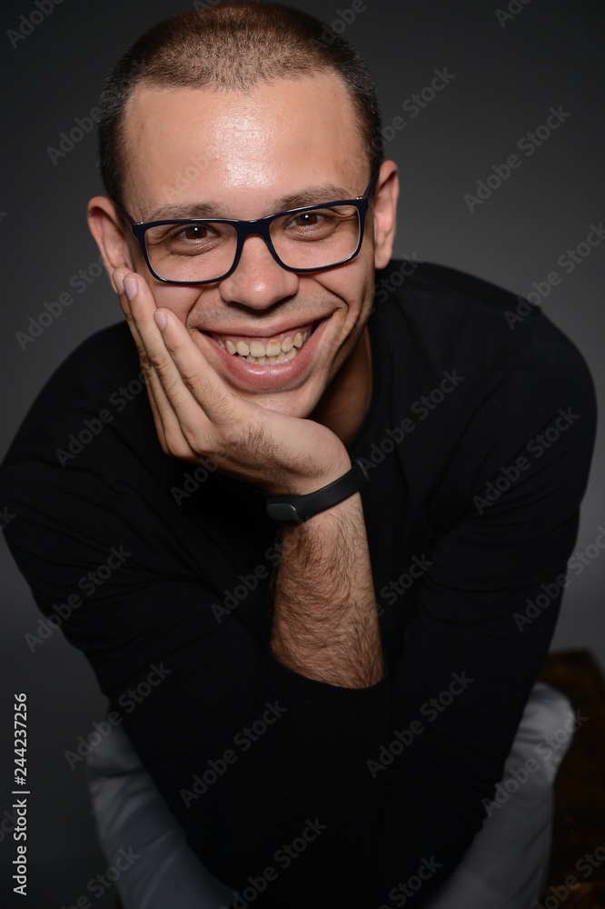 a man in a black jacket shows emotions in the Studio on a black background a man in a black jacket shows emotions in the Studio on a black background