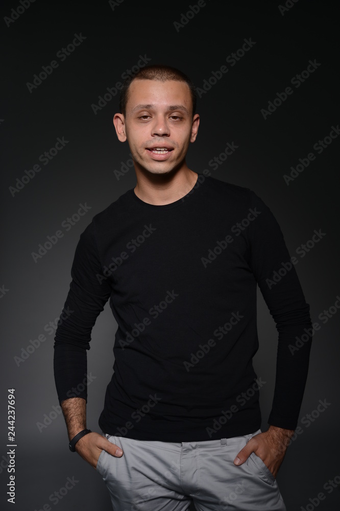 a man in a black jacket shows emotions in the Studio on a black background a man in a black jacket shows emotions in the Studio on a black background